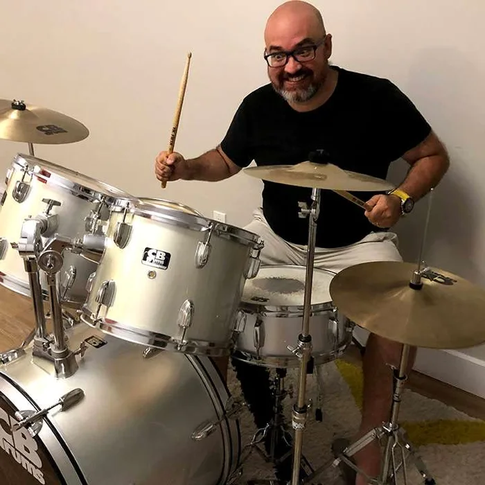 Guilherme playing drums at his church